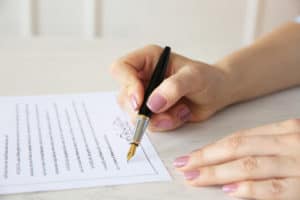 Woman signing marriage contract